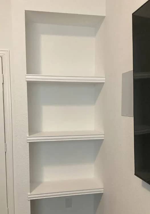 Built-in alcove shelving with moulded shelf edges