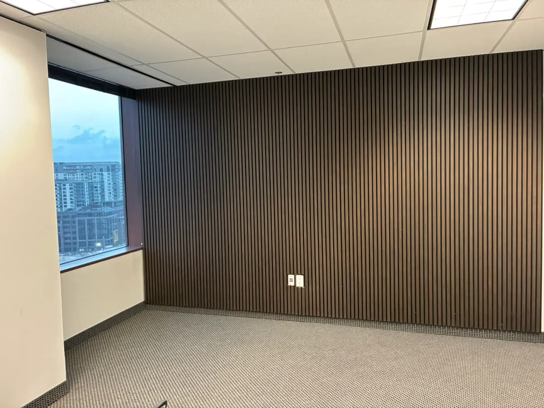 Dark vertical slat wall with integrated display shelves