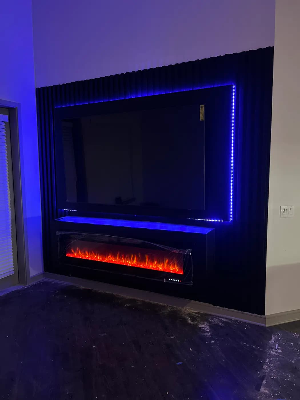 Black fluted media wall during finish installation