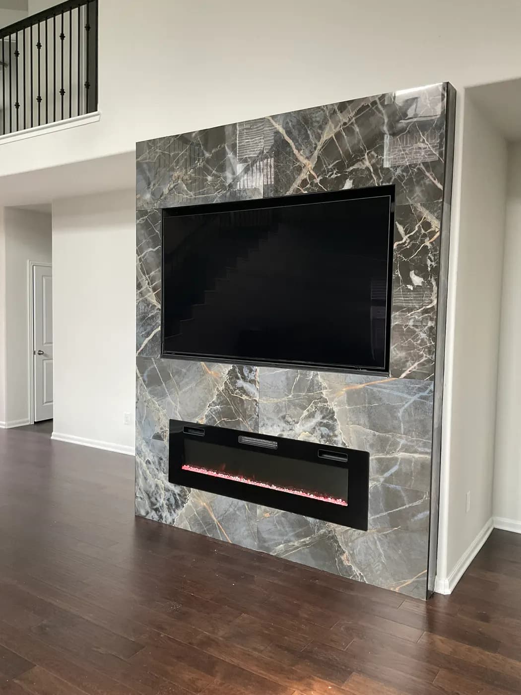 Gray marble media wall with a linear fireplace