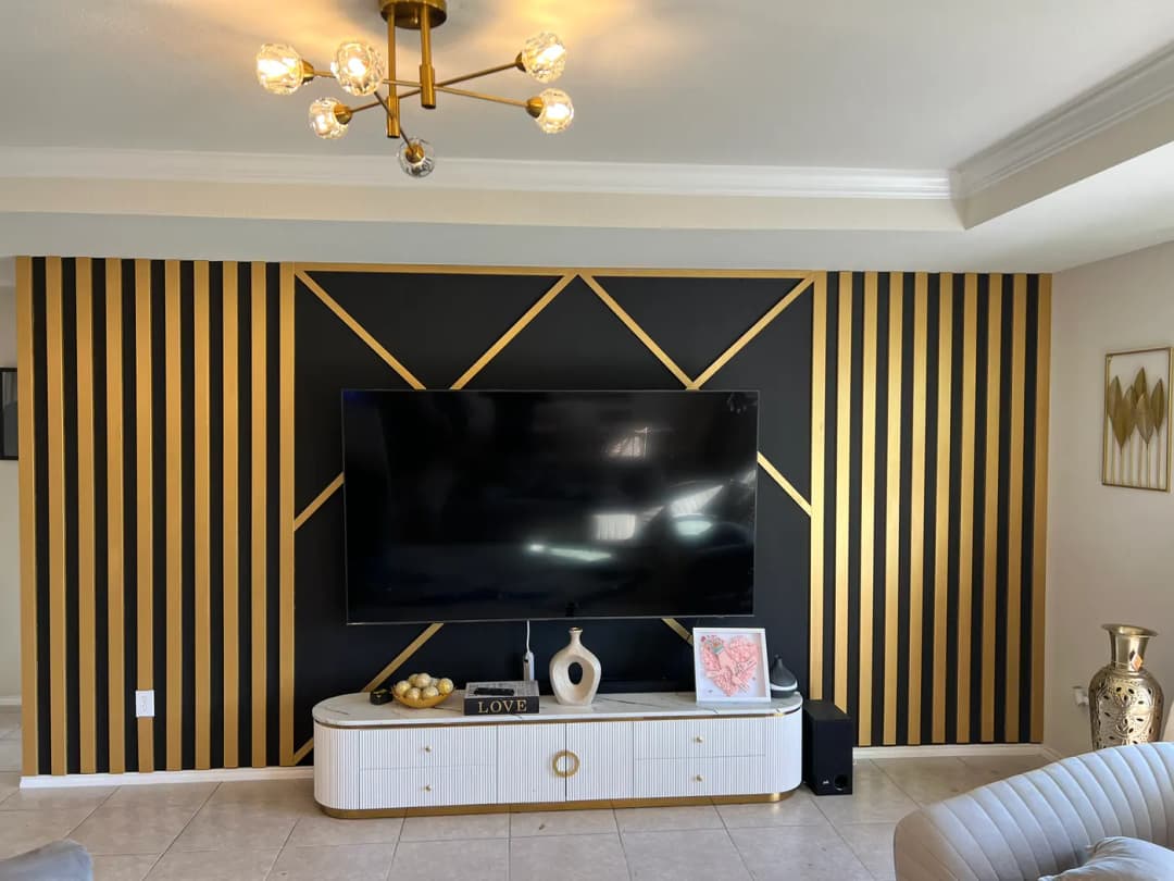 Black feature wall with warm wood framing and gold geometric details