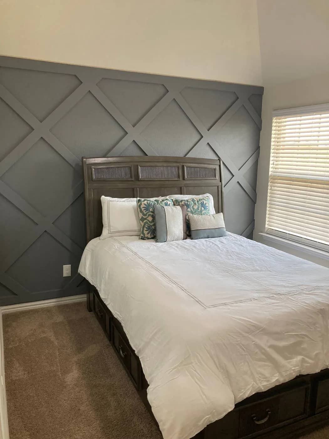 Grey diamond lattice feature wall behind a bed