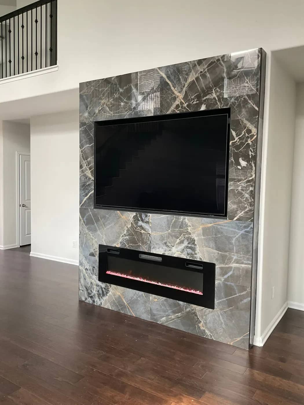 Gray marble media wall with a linear fireplace