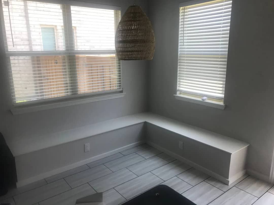 Built-in corner banquette seat running beneath two windows